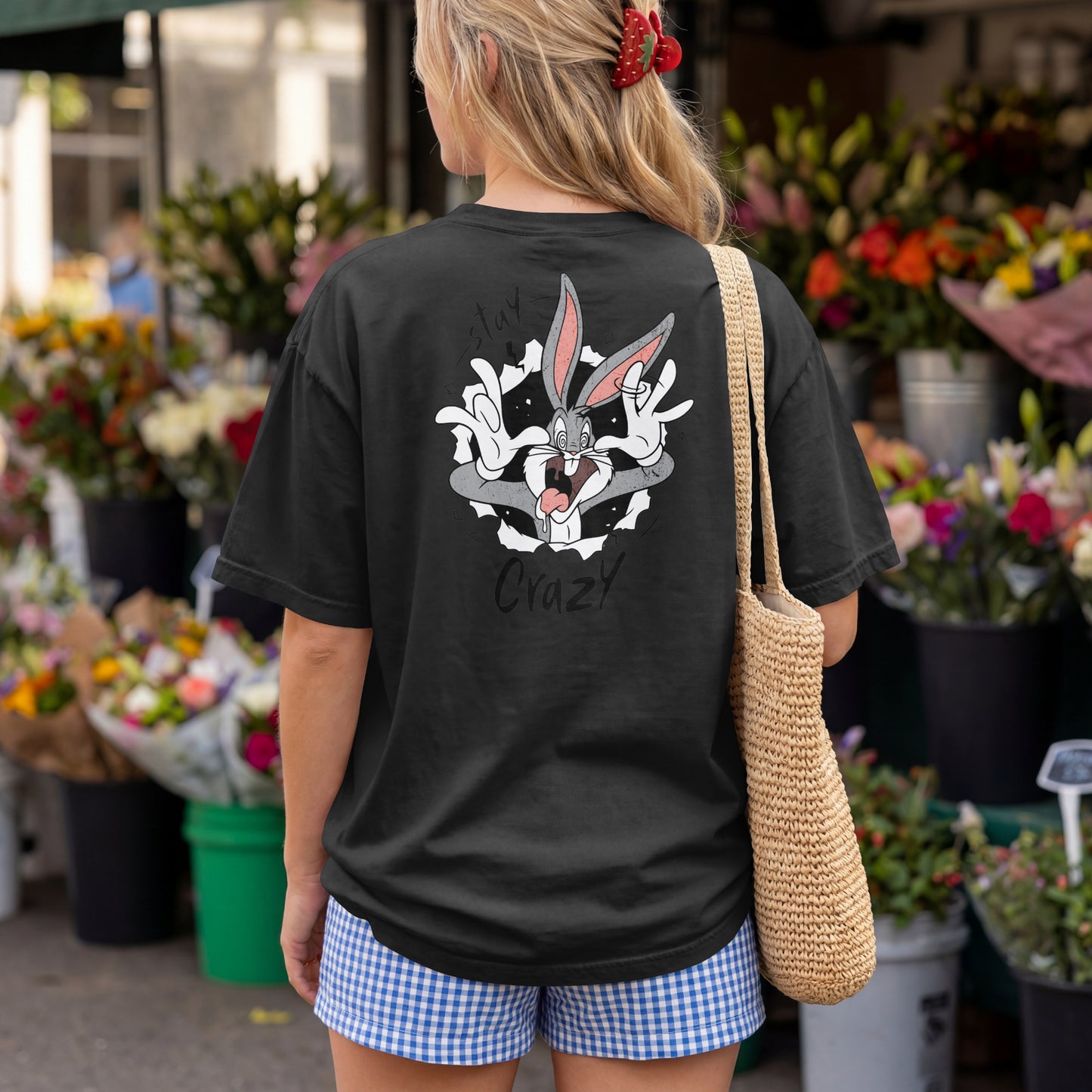 Grey oversized unisex t-shirt with a Stay Crazy Bugs Bunny graphic breaking through the fabric, back view