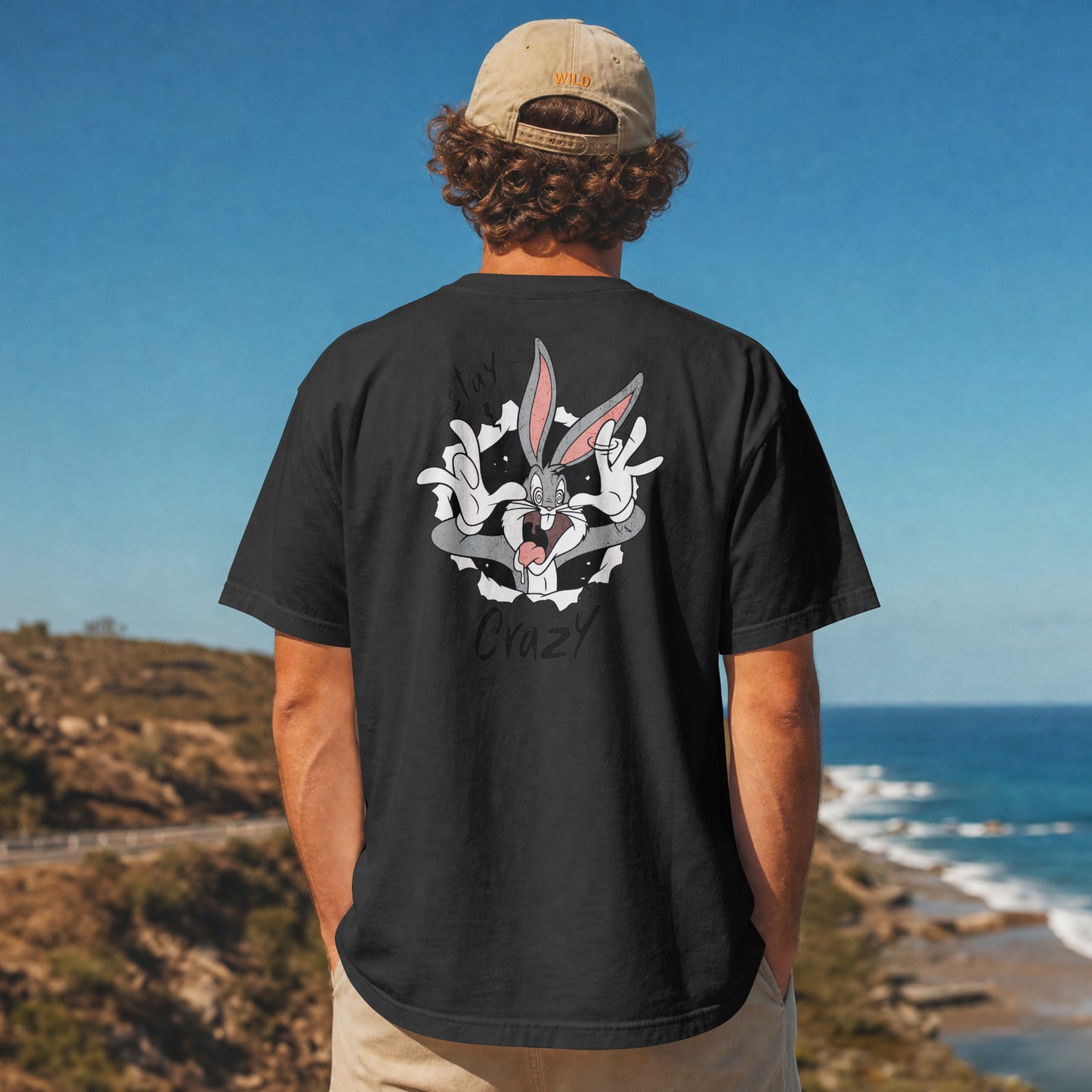 Grey oversized unisex t-shirt with a Stay Crazy Bugs Bunny graphic breaking through the fabric, back view