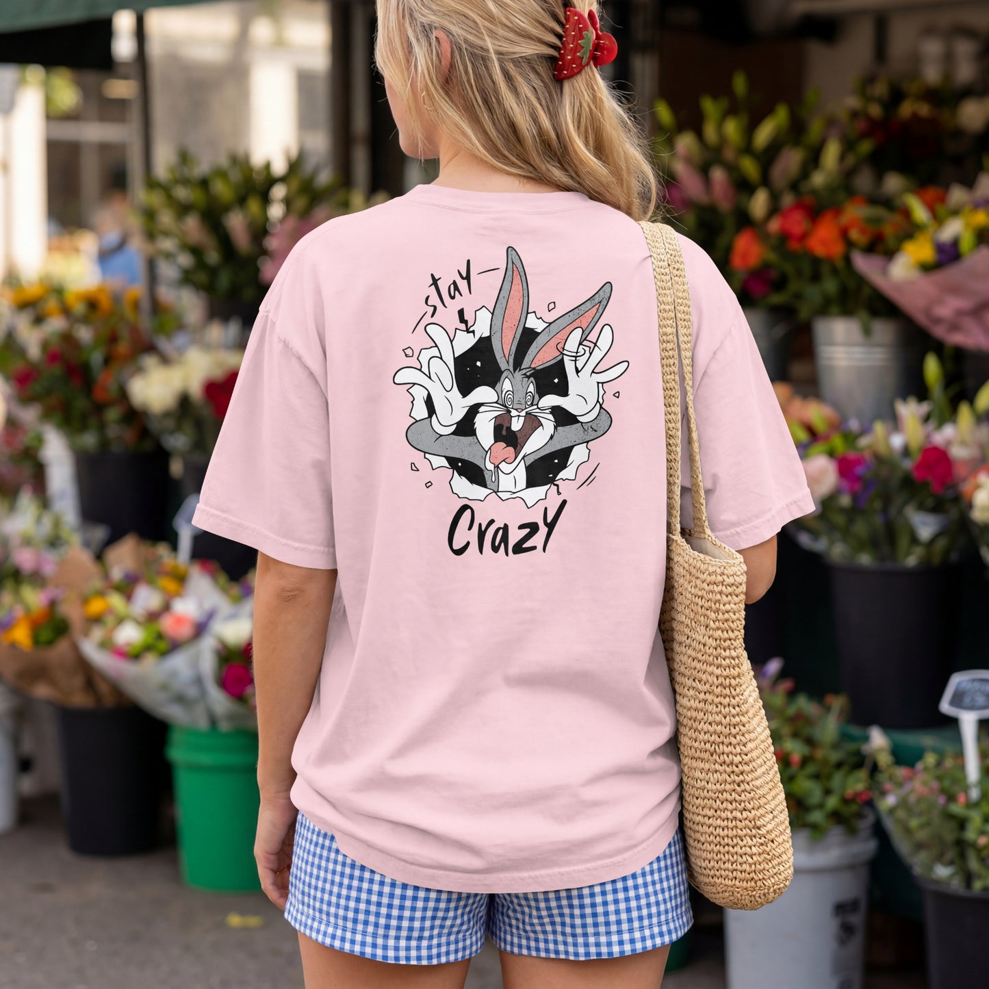 Grey oversized unisex t-shirt with a Stay Crazy Bugs Bunny graphic breaking through the fabric, back view