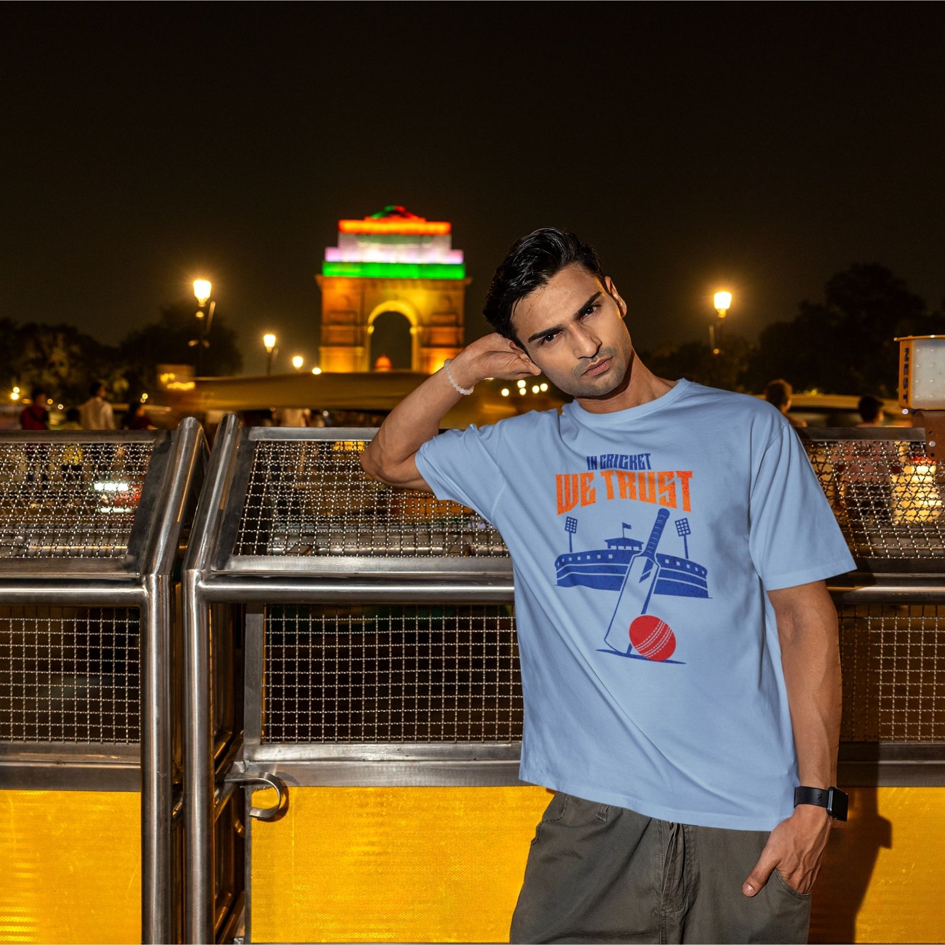 In Cricket We Trust oversized t-shirt design with cricket bat, ball and stadium graphic