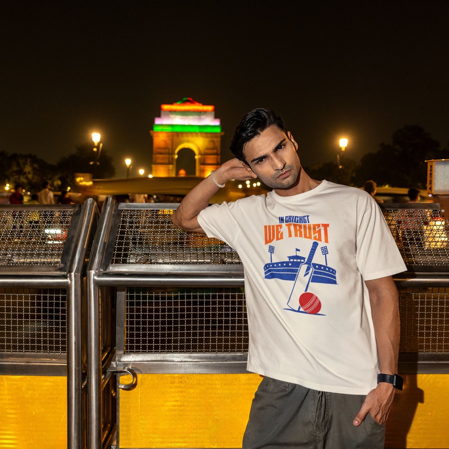 In Cricket We Trust oversized t-shirt design with cricket bat, ball and stadium graphic