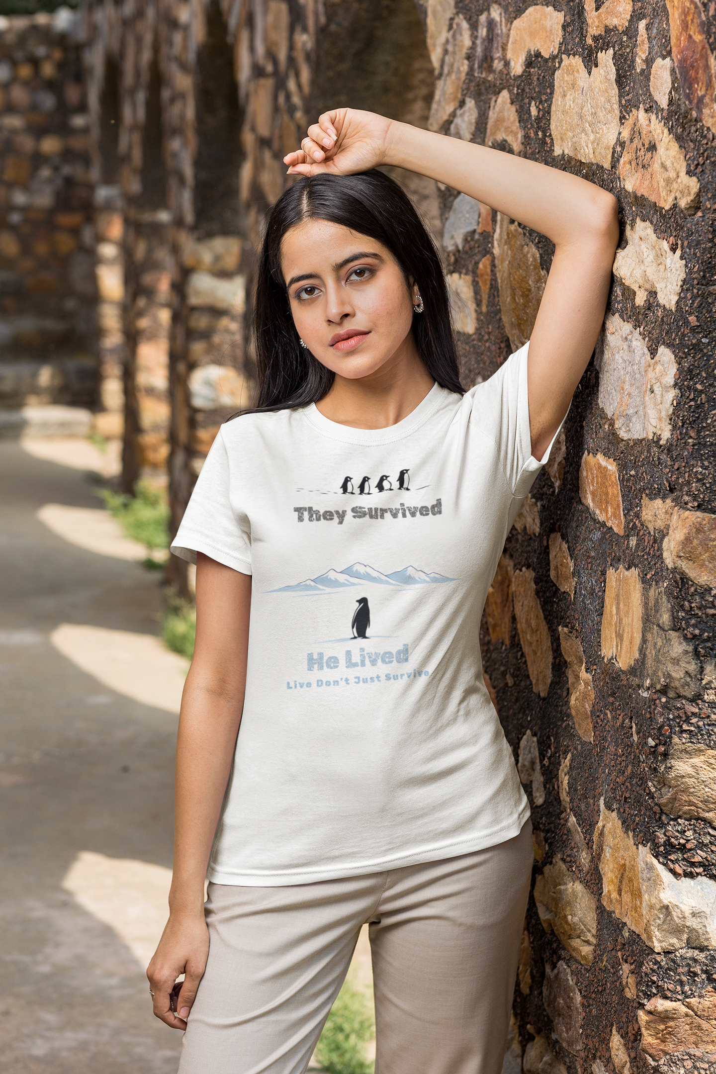 Minimalist penguin design with inspirational quote “They survived. He lived.” t-shirt style graphic.